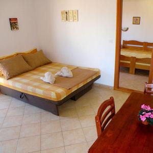 Postel nebo postele na pokoji v ubytování Apartments Ana