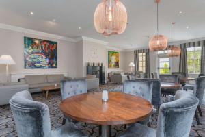 a living room with a table and chairs at Park Inn by Radisson Shannon Airport in Shannon