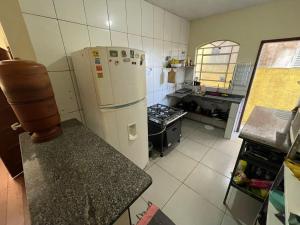 a kitchen with a refrigerator and a stove at República Tabajara in Ouro Preto