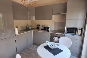 a kitchen with a table and a bowl on it at Le triplex de Sergio in Bonneville