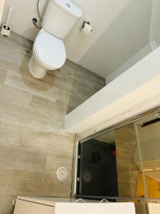 a bathroom with a toilet and a mirror at Apartamento Alfama - Lisbon in Lisbon