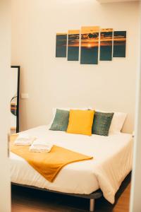 a bedroom with a large bed with yellow and green pillows at Nascer Do Sol Retreat Villa in Conceição