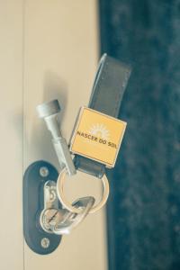 a key chain with a master do so sign on a door at Nascer Do Sol Retreat Villa in Conceição