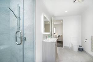 a bathroom with a shower and a sink and a toilet at Riverview Retreat-4 bedrooms Brand New House In Hamilton in Hamilton +31 photos