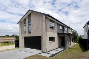 a brick house with a large garage at Riverview Retreat-4 bedrooms Brand New House In Hamilton in Hamilton