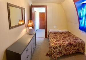 a bedroom with a bed and a dresser and a mirror at Lakeview Terrace Resort in Lewiston +136 photos