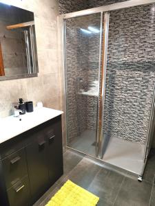 a bathroom with a shower with a glass door at Piso de Alba in Chantada +19 photos