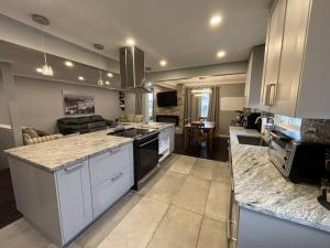 a kitchen with white cabinets and a counter top at Full House - 5 Bed, 2 Bath - East in Windsor