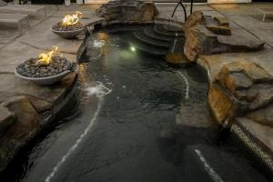 a pond with three bowls with candles in it at Xhale Resort & Spa - ADULTS ONLY RESORT in Idaho Falls
