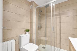 a bathroom with a toilet and a shower at Sea View Penthouse in Vilanova i la Geltrú +20 photos