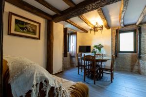 a bedroom with a table and a dining room at Casas do Gato in Valezim