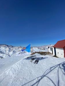 a building in the snow with skis in front of it at Refugio Inka in Los Molles