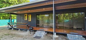 a house with large glass windows on the side of it at Cahuita Nest Containers studio homes in Cahuita