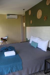 a bedroom with two beds with blue and white pillows at LOL-HA Hotel Boutique in Cancún