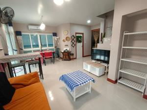 a living room with a couch and a table at Be Cute Family and Pet Friendly Stay in Ban Khung Taphao