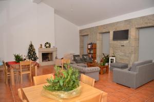 a living room with a christmas tree and a fireplace at Quinta do Eido in Póvoa de Lanhoso