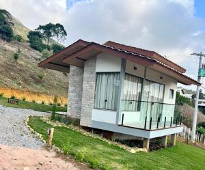a small house on the side of a hill at Pousada Refúgio Pietra Blu in Domingos Martins