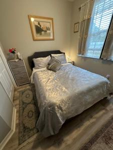 a bedroom with a bed and a window at Quiet room in a family home in Lehigh Acres