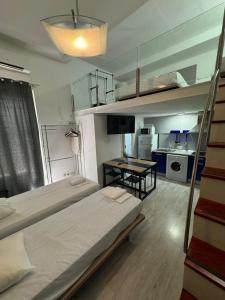 a bedroom with a bunk bed and a kitchen at Apartamentos Sol Mayor in Madrid