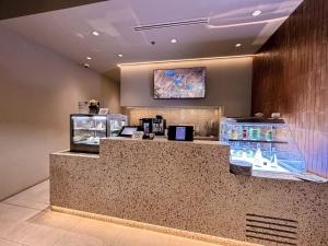 a counter in a restaurant with a counter sidx sidx sidx at Citadines Gatot Subroto Jakarta in Jakarta