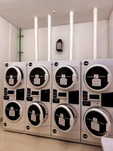 a group of four washing machines in a room at Citadines Gatot Subroto Jakarta in Jakarta