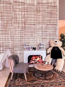 a living room with a teddy bear and a fireplace at Citadines Gatot Subroto Jakarta in Jakarta