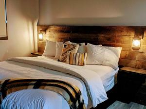 ein Schlafzimmer mit einem großen Bett mit einem hölzernen Kopfteil in der Unterkunft Skyline Suite 2Bdrm King in Valemount