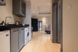 a kitchen with a washer and dryer in a room at Gazala Hotel in Riyadh