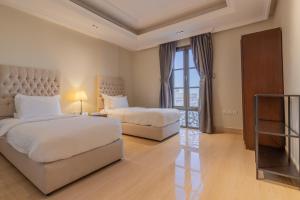 Ένα ή περισσότερα κρεβάτια σε δωμάτιο στο Gazala Hotel
