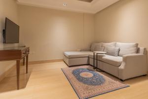 a living room with a couch and a table at Gazala Hotel in Riyadh