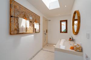 une salle de bains avec un lavabo et un miroir dans l'établissement Villa Eden at Nyanyi, à Canggu
