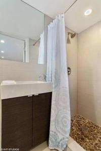 a bathroom with a sink and a shower curtain at KAWAMA K1 in Key Largo, Beach, Lagoon, Pools, Tennis, Free Bikes and Canoes in Key Largo