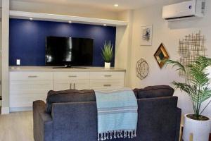 a living room with a couch and a flat screen tv at KAWAMA K1 in Key Largo, Beach, Lagoon, Pools, Tennis, Free Bikes and Canoes in Key Largo