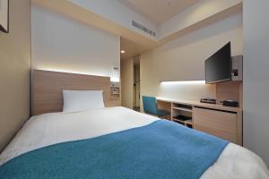 Postel nebo postele na pokoji v ubytování Keio Presso Inn Tokyo Kudanshita