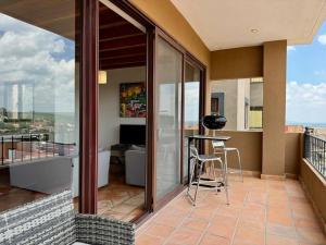a balcony with a table and a view of the ocean at Charming No Stairs Near DT Security Pool Parking in San Miguel de Allende