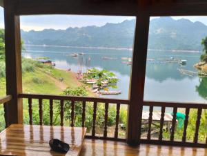 a view of a lake from a window at Bảo lộc homestay in Ðà Bắc +22 photos