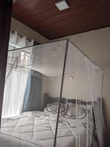 a bed with a canopy in a bedroom at New look apartment in Bugesera