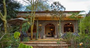 a house with an umbrella in front of it at Nzuri House in Nairobi