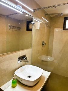 a bathroom with a white sink and a shower at Hotel Relax Inn in Bānswāra