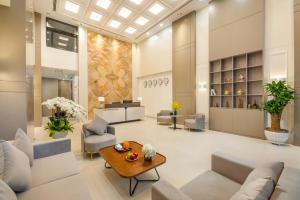 a living room with couches and a table at Gilson Hanoi Hotel in Hanoi