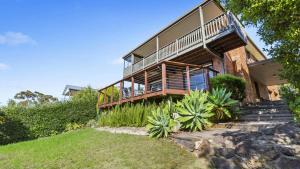 a house with a large deck on the side of it at Sea For Days - Panoramic Bay Views in Rye in Rye