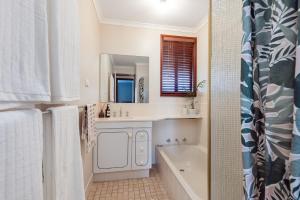 a bathroom with a tub and a sink and a mirror at Roo With A View By Swan Bnb Management in Preston Beach