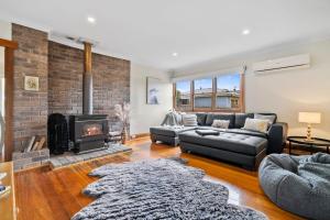 a living room with a couch and a fireplace at Beach Holiday Home-Close to Airport-3 Bed & 2 Bath in Lauderdale