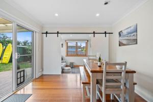 a dining room with a table and chairs and a room with a window at Beach Holiday Home-Close to Airport-3 Bed & 2 Bath in Lauderdale