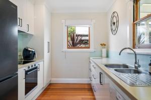 a kitchen with a sink and a window at Beach Holiday Home-Close to Airport-3 Bed & 2 Bath in Lauderdale