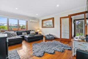 a living room with a couch and a table at Beach Holiday Home-Close to Airport-3 Bed & 2 Bath in Lauderdale