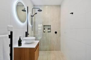 a bathroom with a sink and a shower at Beach Holiday Home-Close to Airport-3 Bed & 2 Bath in Lauderdale