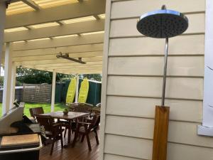a patio with a table and chairs and a pergola at Beach Holiday Home-Close to Airport-3 Bed & 2 Bath in Lauderdale