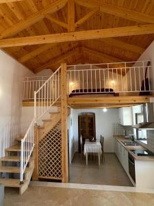 a room with a loft bed and a kitchen with a table at Levanta in Kastrisiánika +15 photos