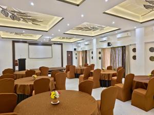 a conference room with tables and chairs and a projection screen at Tathastu Tadoba in Mohurli +86 photos